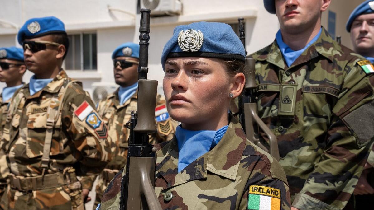 A peacekeeper is photographed in a crowd.