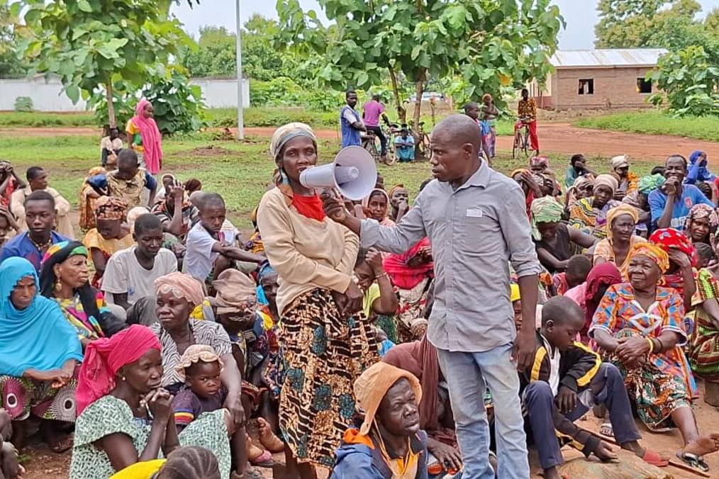 Une personne parle dans un mégaphone depuis le public.