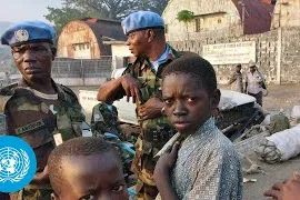 un peacekeepers standing with children